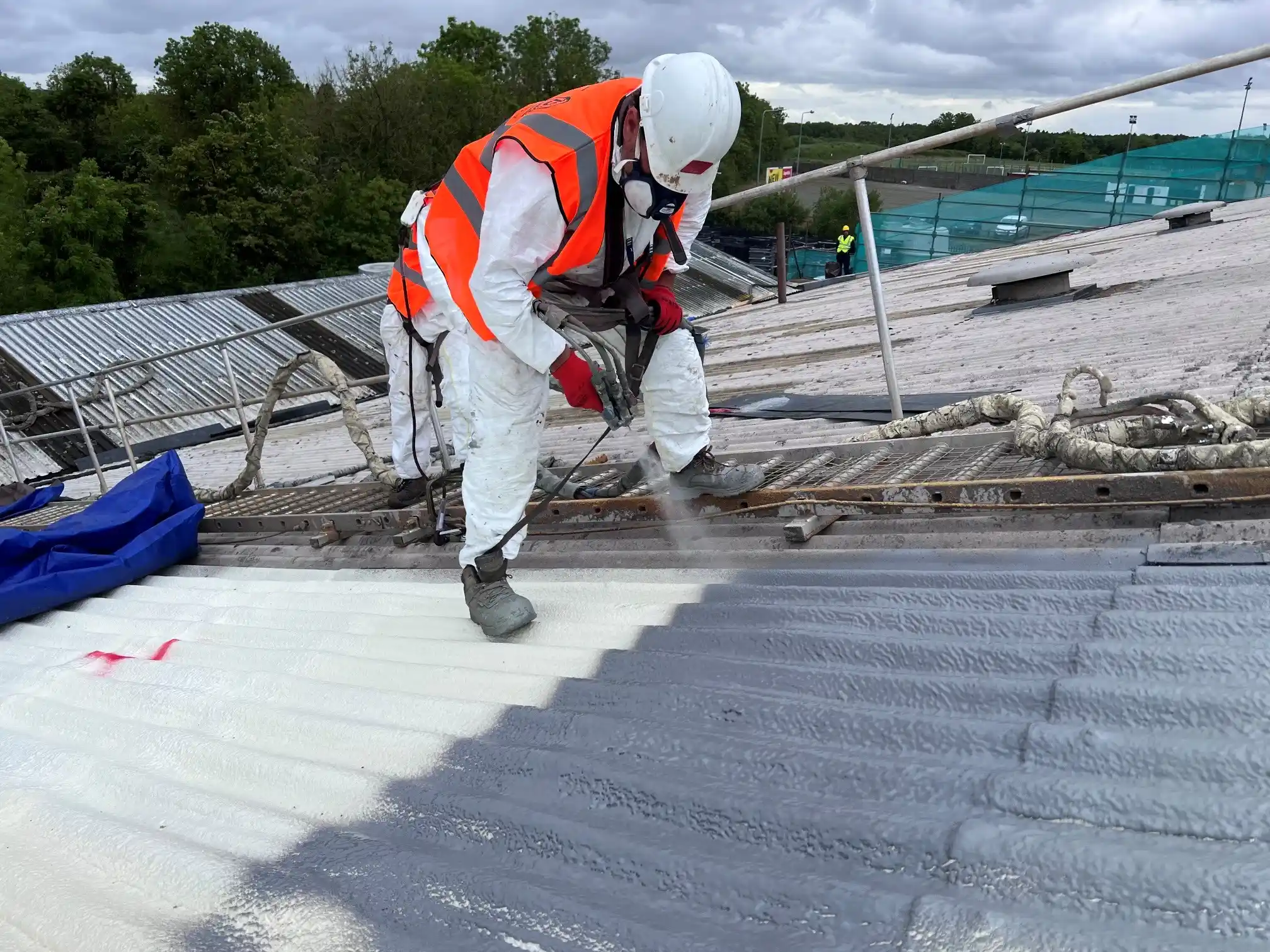 Professional asbestos encapsulation coating application on Irish industrial warehouse roof - HSA-licensed specialists